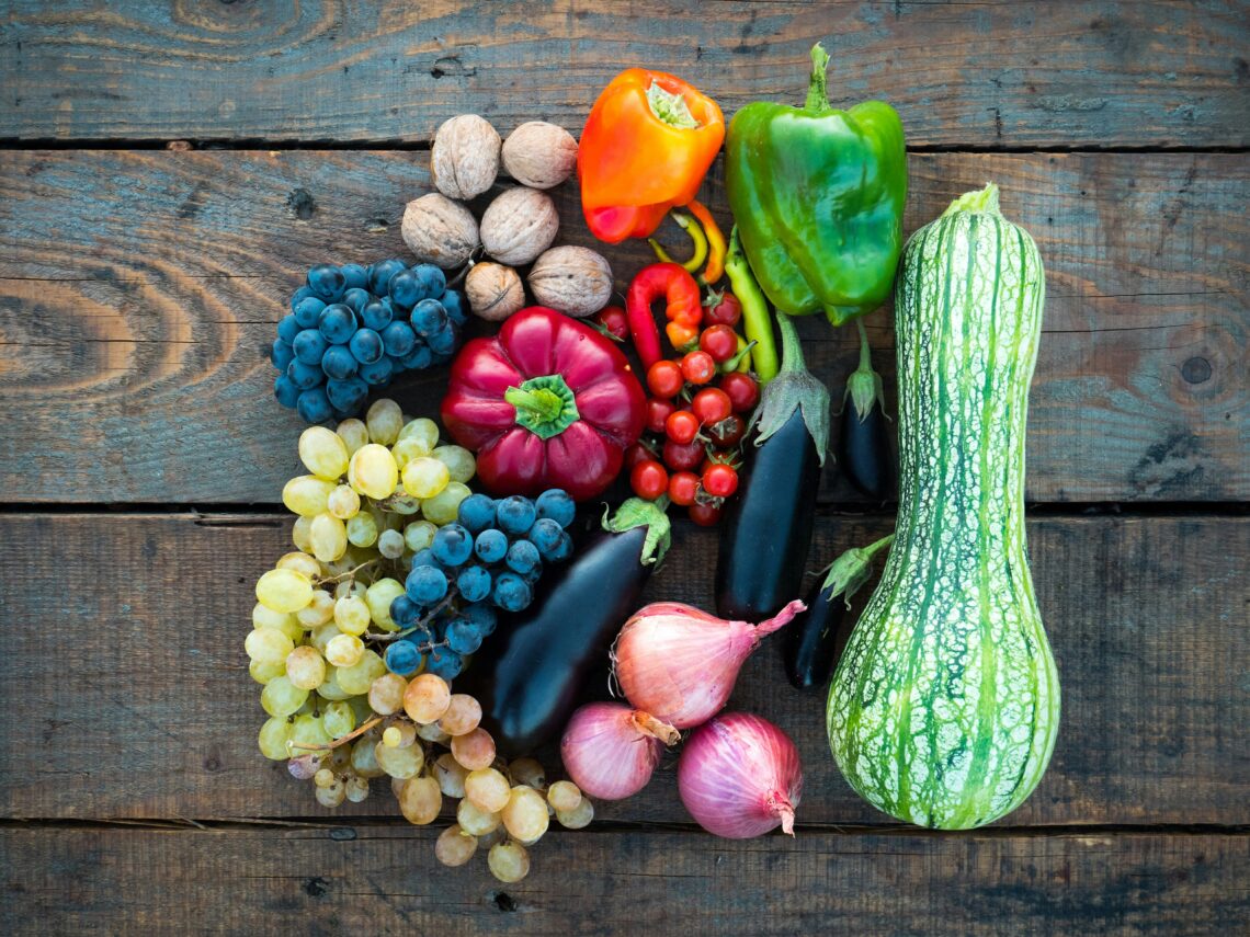 An assortment of fruits and vegetables on a wooden table.