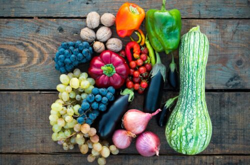 An assortment of fruits and vegetables on a wooden table.