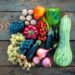 An assortment of fruits and vegetables on a wooden table.